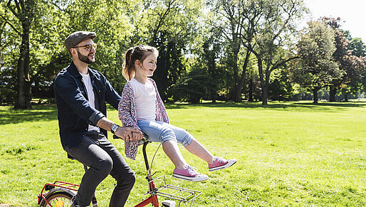 quality-of-life-young-man-with-child-on-bicycle